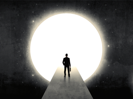 businessman standing in front of the huge circle gateの写真素材