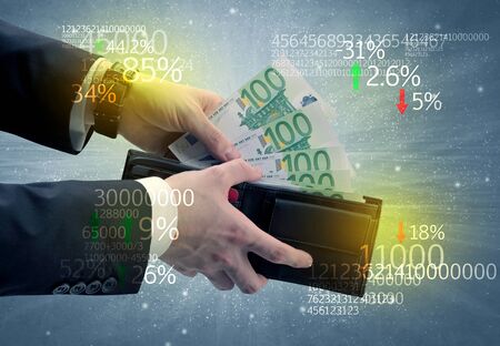 Businessman and takes out euro from wallet with stock exchange themeの写真素材