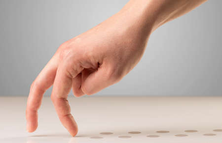 Female fingers walking with dots behind themの写真素材