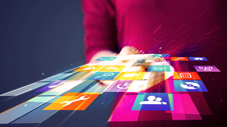 Woman holding smart phone with colorful application icons comming out
