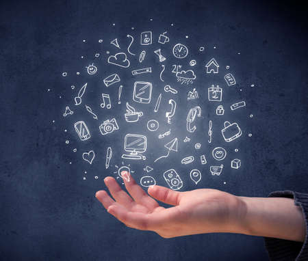 Mixed white media and communication related icons hovering above young handの写真素材