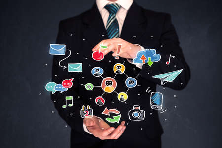 Colorful hand-drawn social media icons in the hands of a businessmanの写真素材