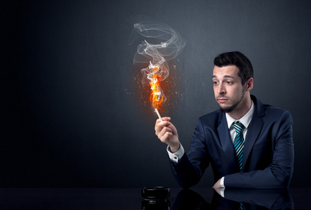 Businessman smoking with inferno effect.の写真素材