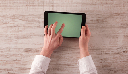 Caucasian business hands holding and working on plain tabletの写真素材