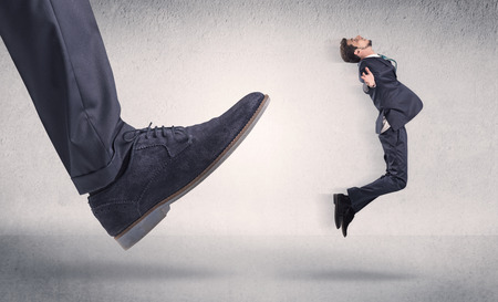 Small businessman deported from workplace by his bossの写真素材