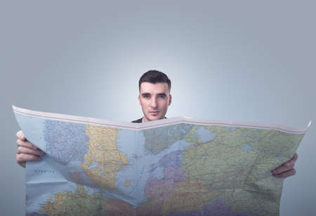Handsome young man holding mapの写真素材