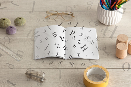 Open notebook on the floor with office instruments nearby and letters on itの写真素材