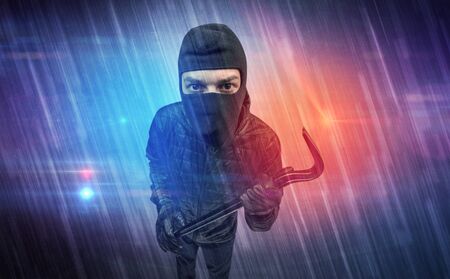Burglar in action with colorful concept.の写真素材
