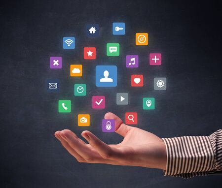 Colorful applications hovering over young handの写真素材