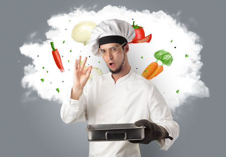 Drawn vegetables on cloud with male cook and kitchen toolsの写真素材