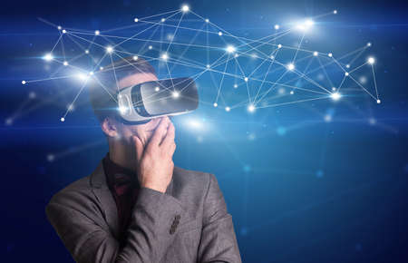 Amazed businessman with virtual reality network concept in front of him