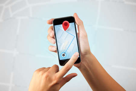 Female fingers touching smartphone with mapの写真素材