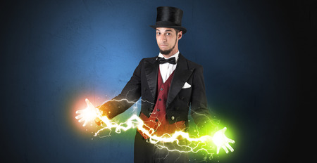Magician sparkling super power between his two handsの写真素材