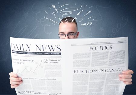 Confused businessman holding newspaper の写真素材