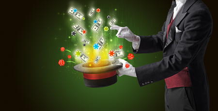 Illusionist conjure with magic wand gambling things from a cylinderの写真素材