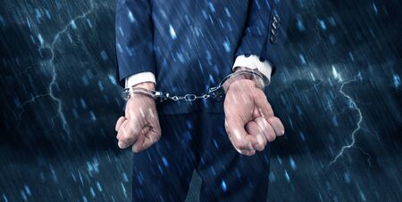Stormy bad day concept with close handcuffed elegant man
