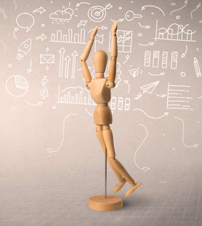 Wooden mannequin posed in front of a greyish background with white scribbled data around himの写真素材