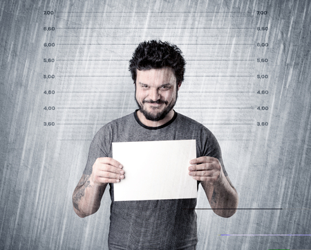 Gangster with rainy, lowering background and table on his hand.の写真素材