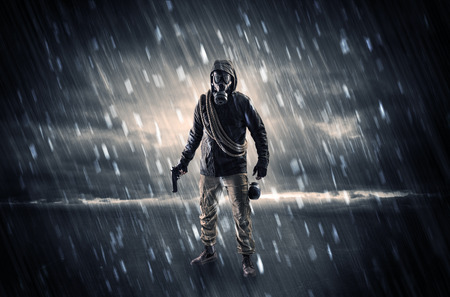 Terrorist in a stormy space with gas mask on his hand and weapons on his arm
の写真素材