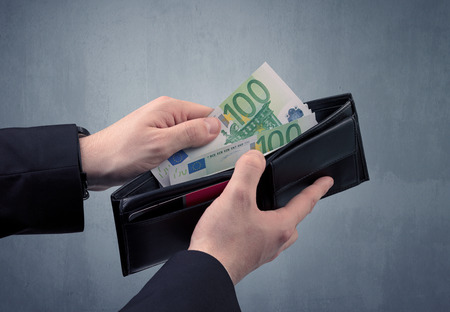 Businessman's hand in suit takes out eruo from his wallet