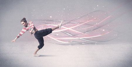 A pretty hip hop dancer dancing contemporary dance illustrated with glowing motion lines in the background concept.の写真素材