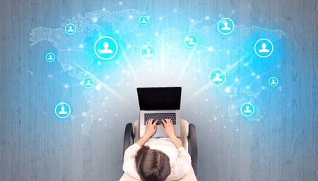 Social media concept with woman sitting on chair with tablet on her hand
の写真素材