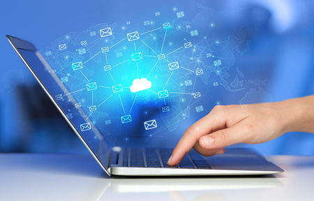 Hand using laptop with centralized cloud computing system concep Hand using laptop with centralized cloud computing system concep