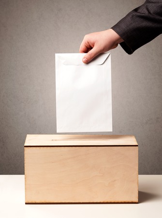 Ballot box with person casting voteの写真素材