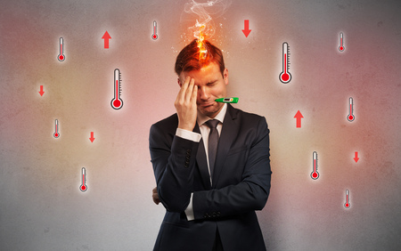 Businessman with thermometer and fever conceptの写真素材