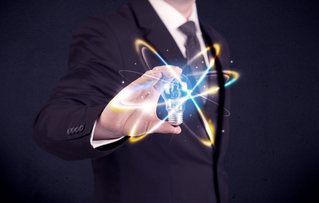 businessman holding a colorful light bulbの写真素材