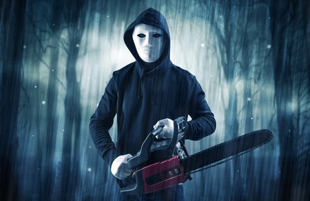 Armed hitman in dark nocturnal forest conceptの写真素材
