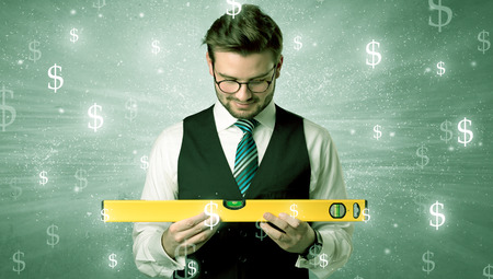 Businassman standing with tool on his hand.
