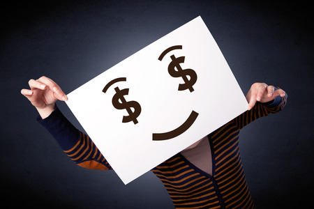 Woman holding paper with greedy emotionの写真素材