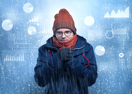 Young hipster shivering with graphs, reports and chart conceptの写真素材