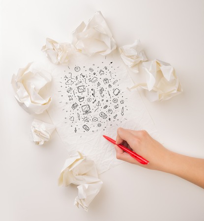 Writing hand in crumpled paperの写真素材
