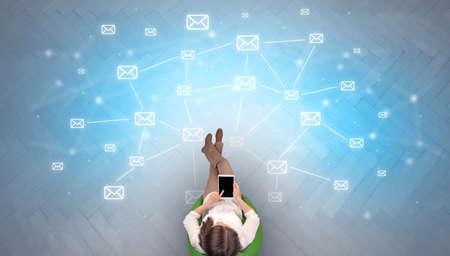 Mail symbols with woman using deviceの写真素材
