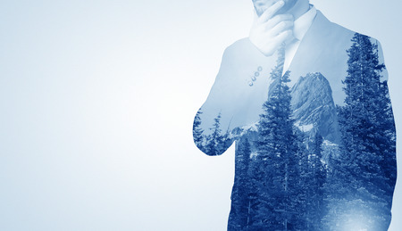 Businessman standing with mountainの写真素材