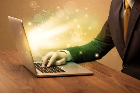 Businessman working fast on laptopの写真素材