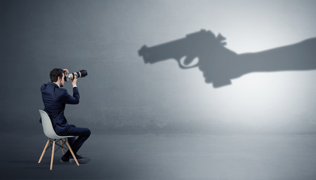 Businessman staying and offering stuffs for an armed shadow hand