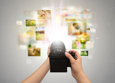 Hand captures life events with digital camera