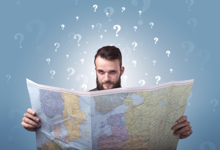 Young man holding mapの写真素材