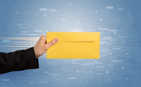 Female hand holding empty and full envelope with blue background and direction concept
の写真素材