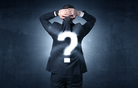Businessman standing and thinking about questionsの写真素材