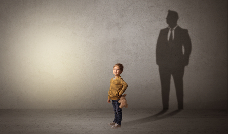 Little boy with businessman shadowの写真素材