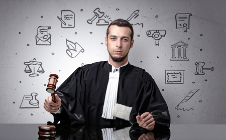Young judge with court symbols aroundの写真素材