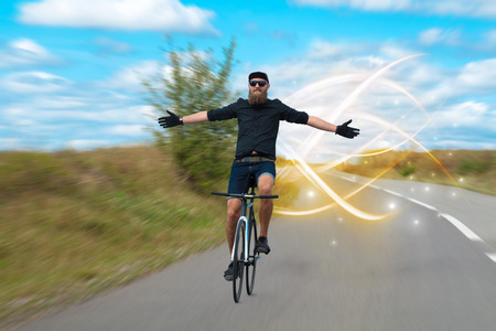 Magical young cyclist ridingの写真素材