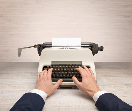 First person perspectve hand writing on an oldschool typewriterの写真素材