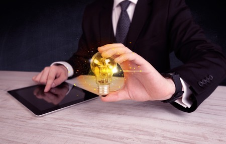 office worker holding a light bulbの写真素材
