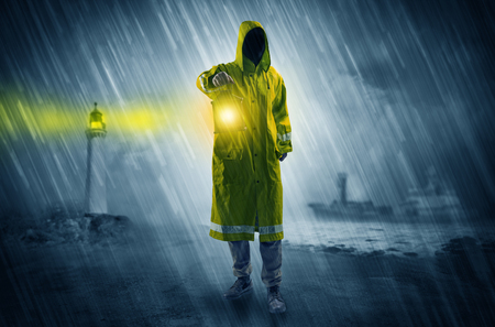 Man coming with lantern at coast conceptの写真素材