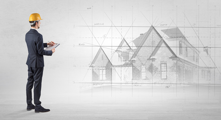 Architect standing with house planの写真素材
